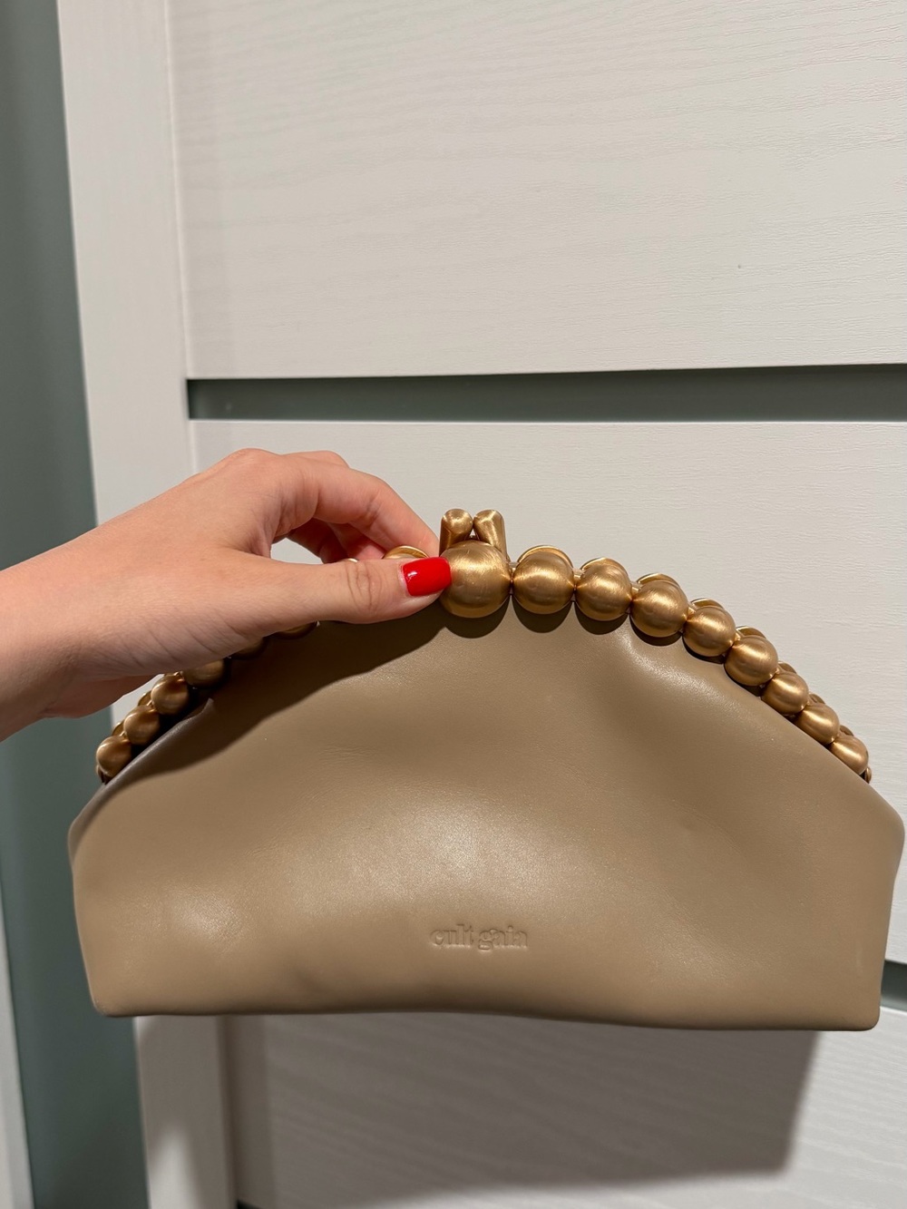cult gaia taupe clutch with sculpted gold bead handle